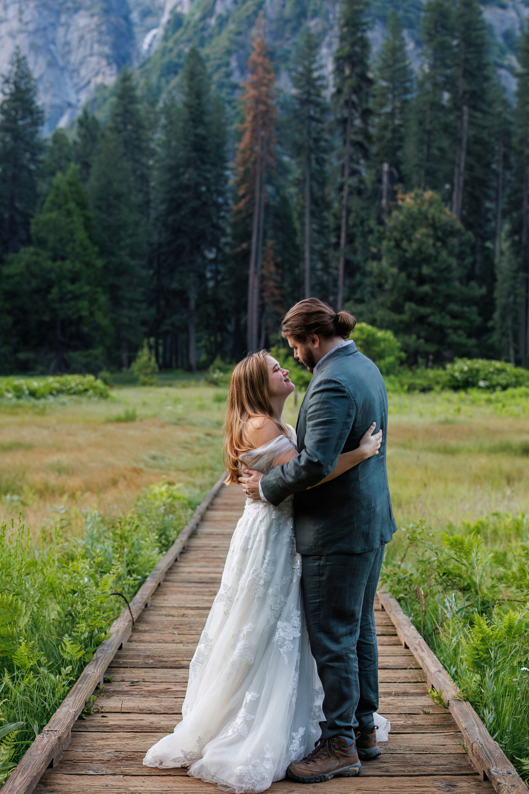 a couple holding each other as they look into each others' eyes