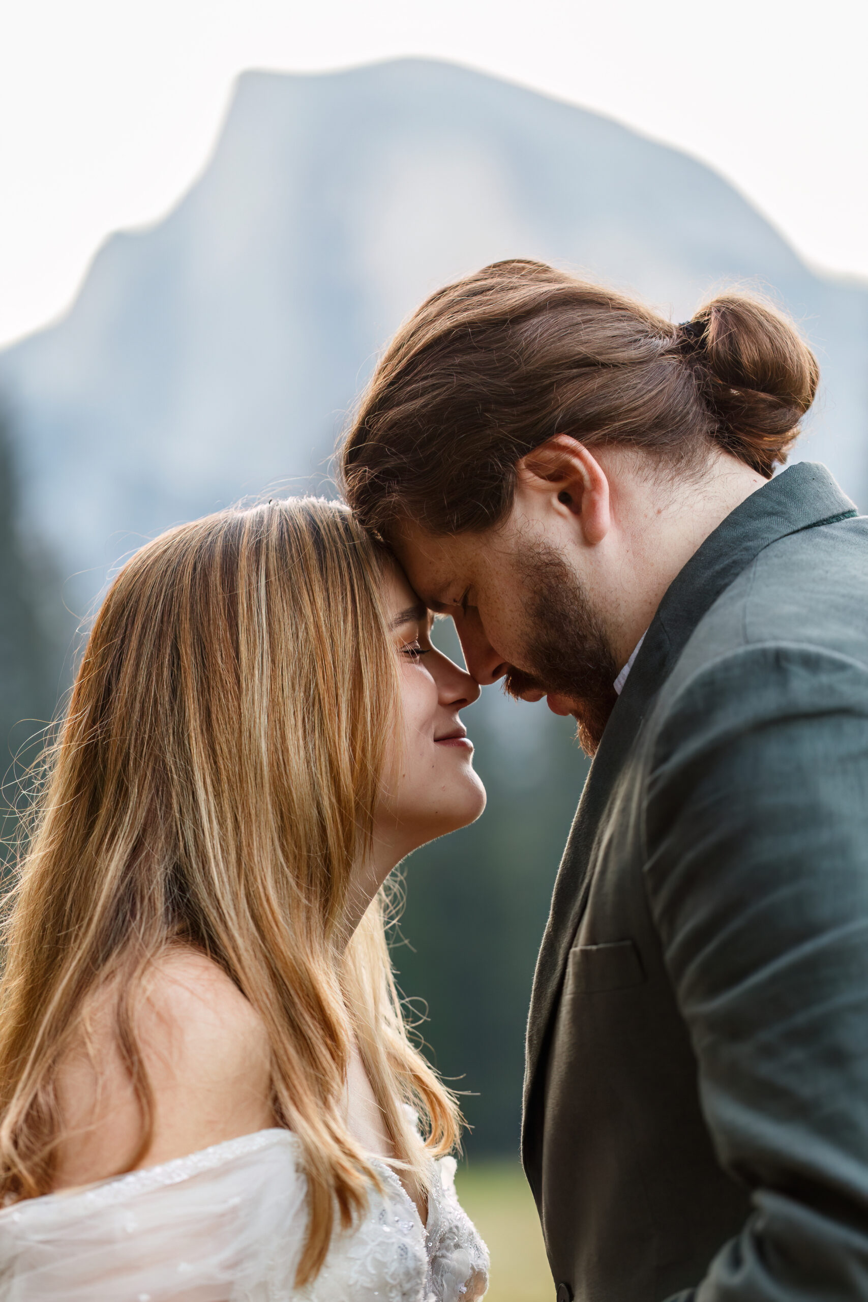 newly weds putting their foreheads together as they close their eyes and soak up the moment