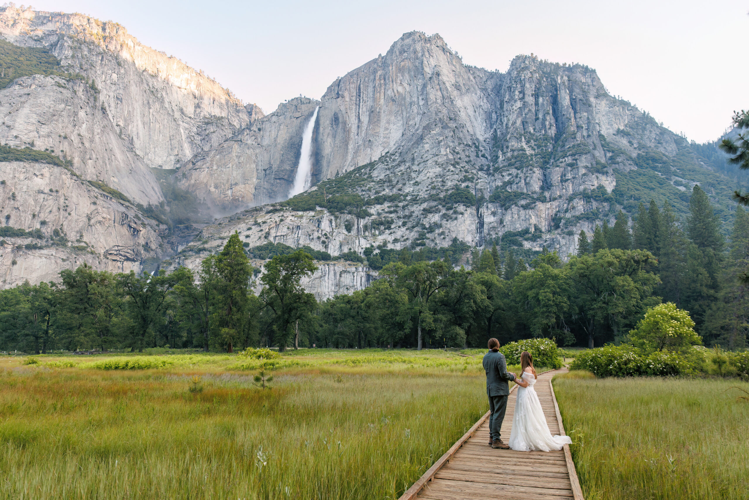 a couple standing together in Yosemite valley during their after session