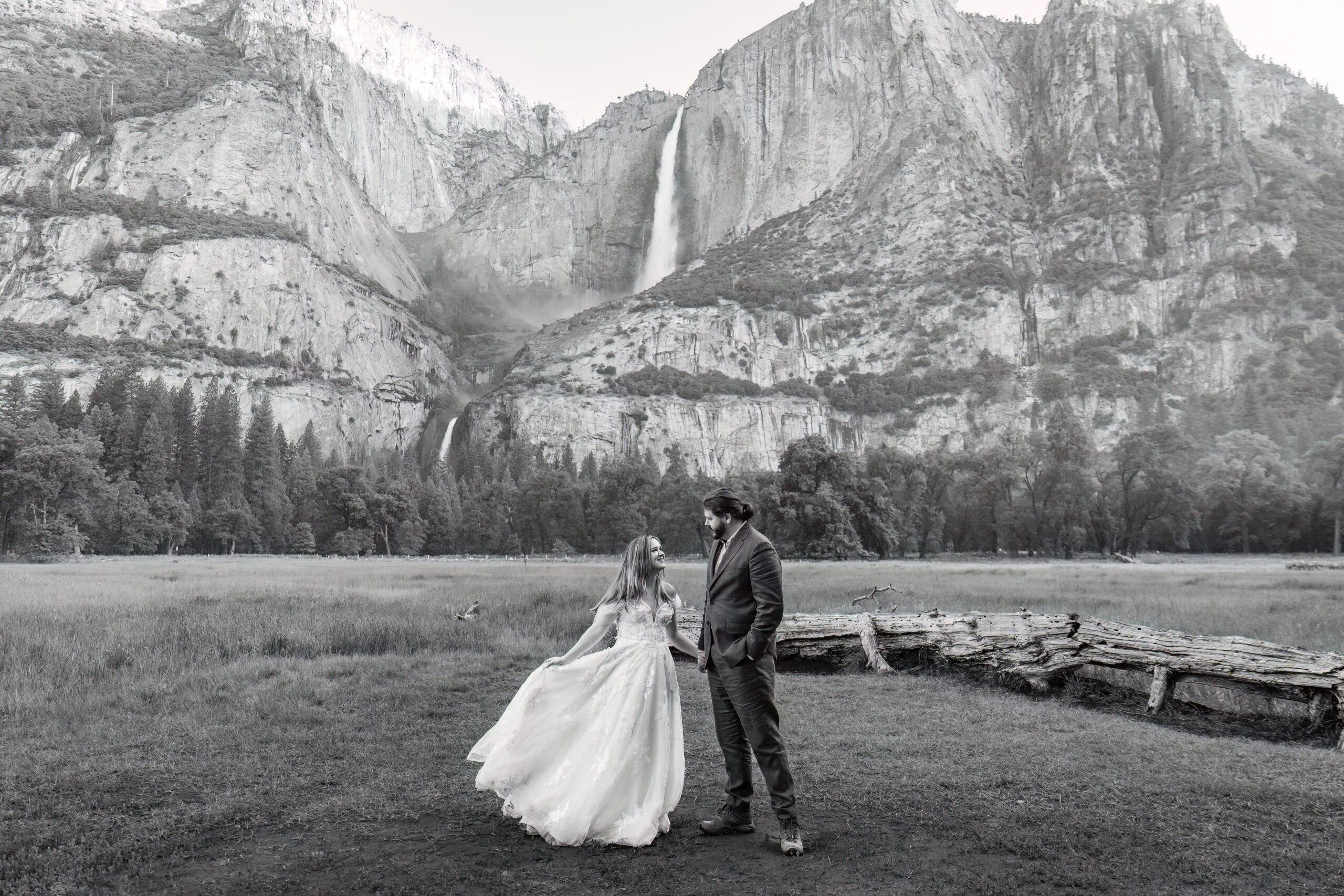 a couple posing in front of a gorgeous waterfall for Yosemite wedding photos