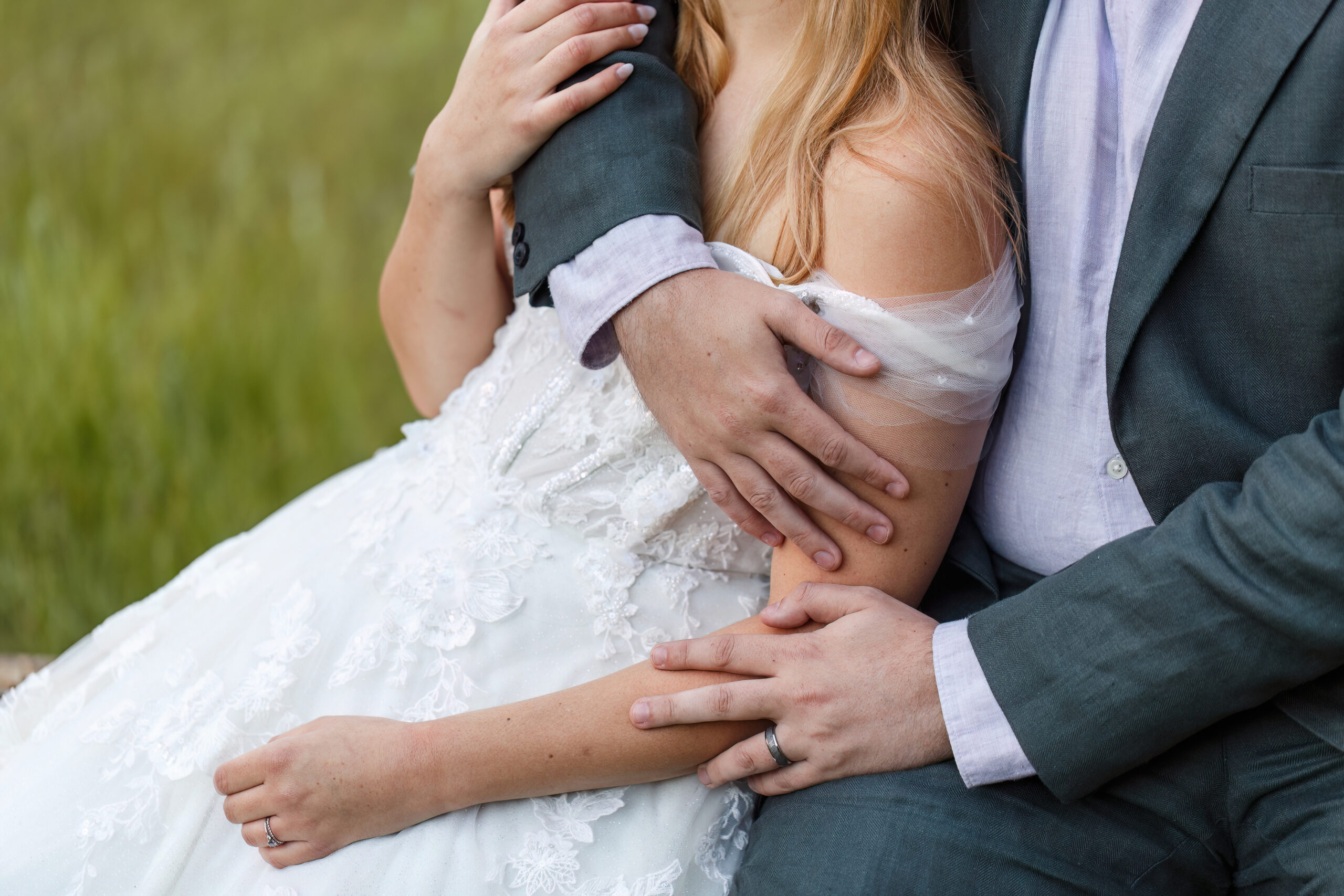 a woman leaning into a man as he wraps his arms around her