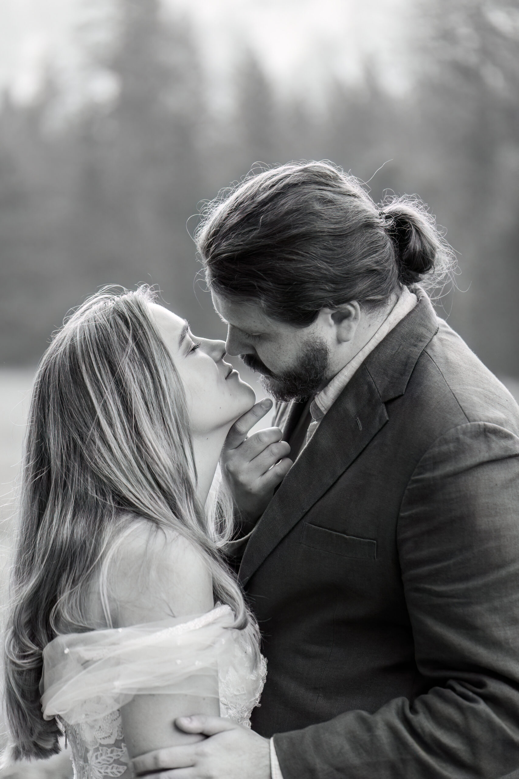 a man holding a woman's chin as he kisses her