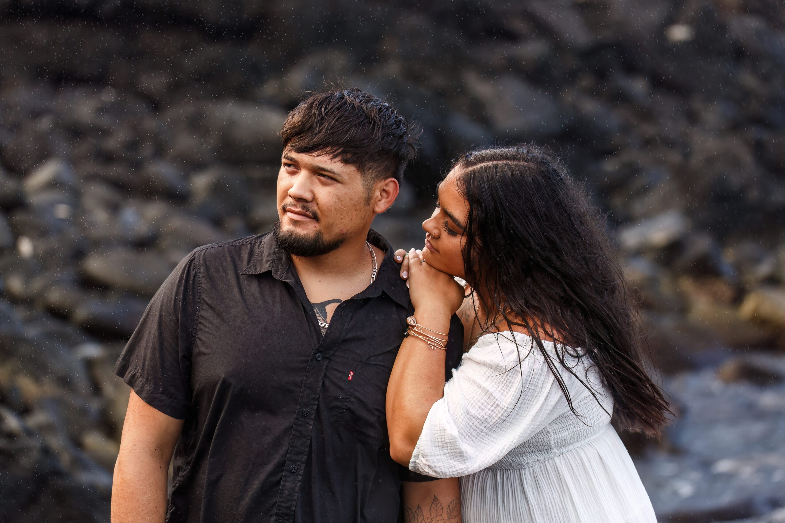 a woman resting her head on a man's shoulder during their Hawaiian elopement