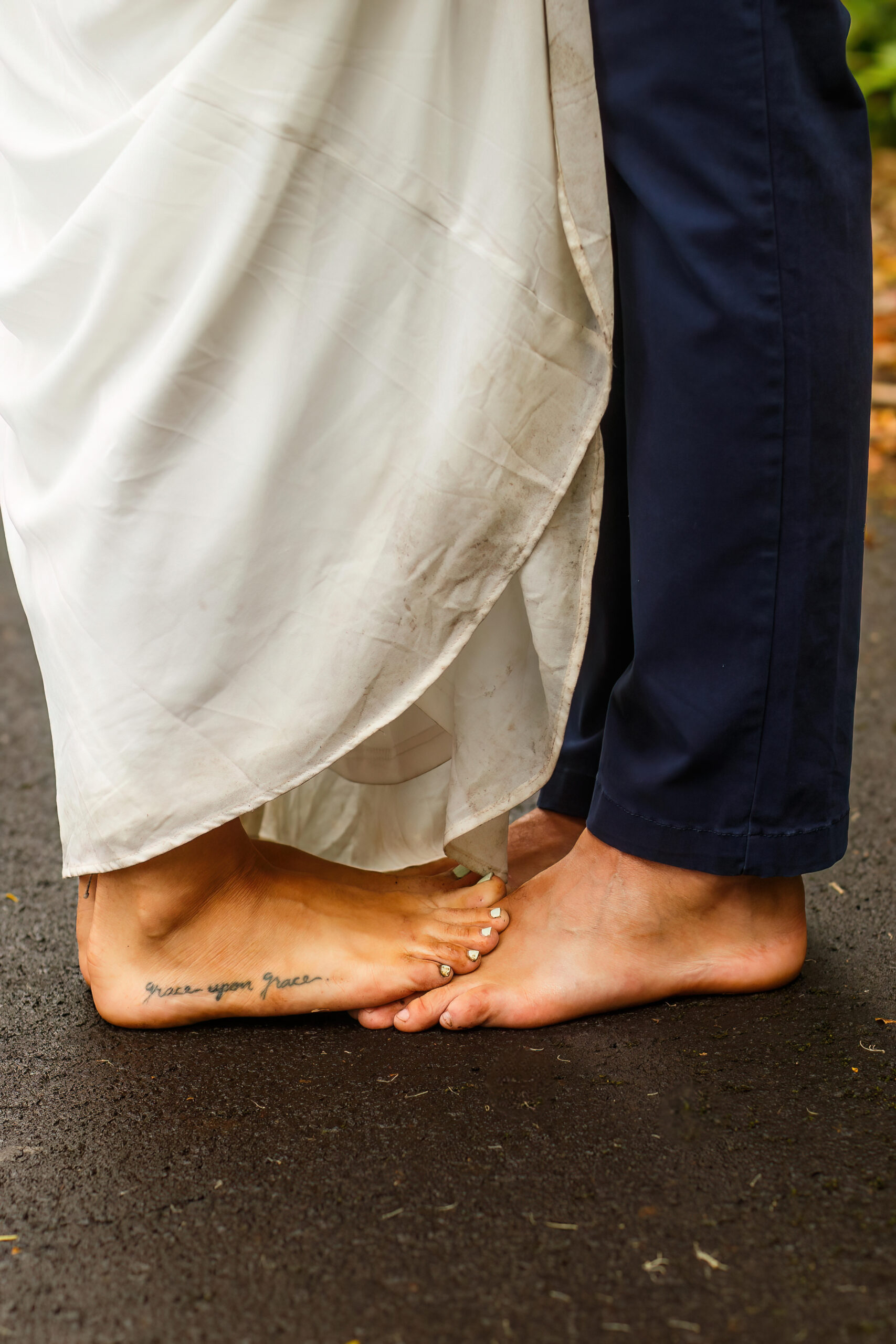 a woman putting her feet on top of a man's feet