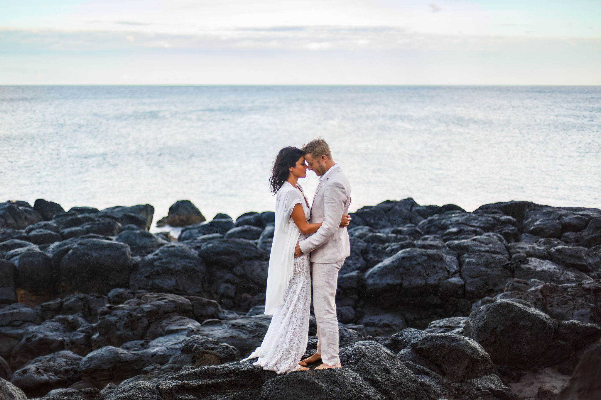 newly weds holding each other and putting their foreheads together during their Hawaiian elopement