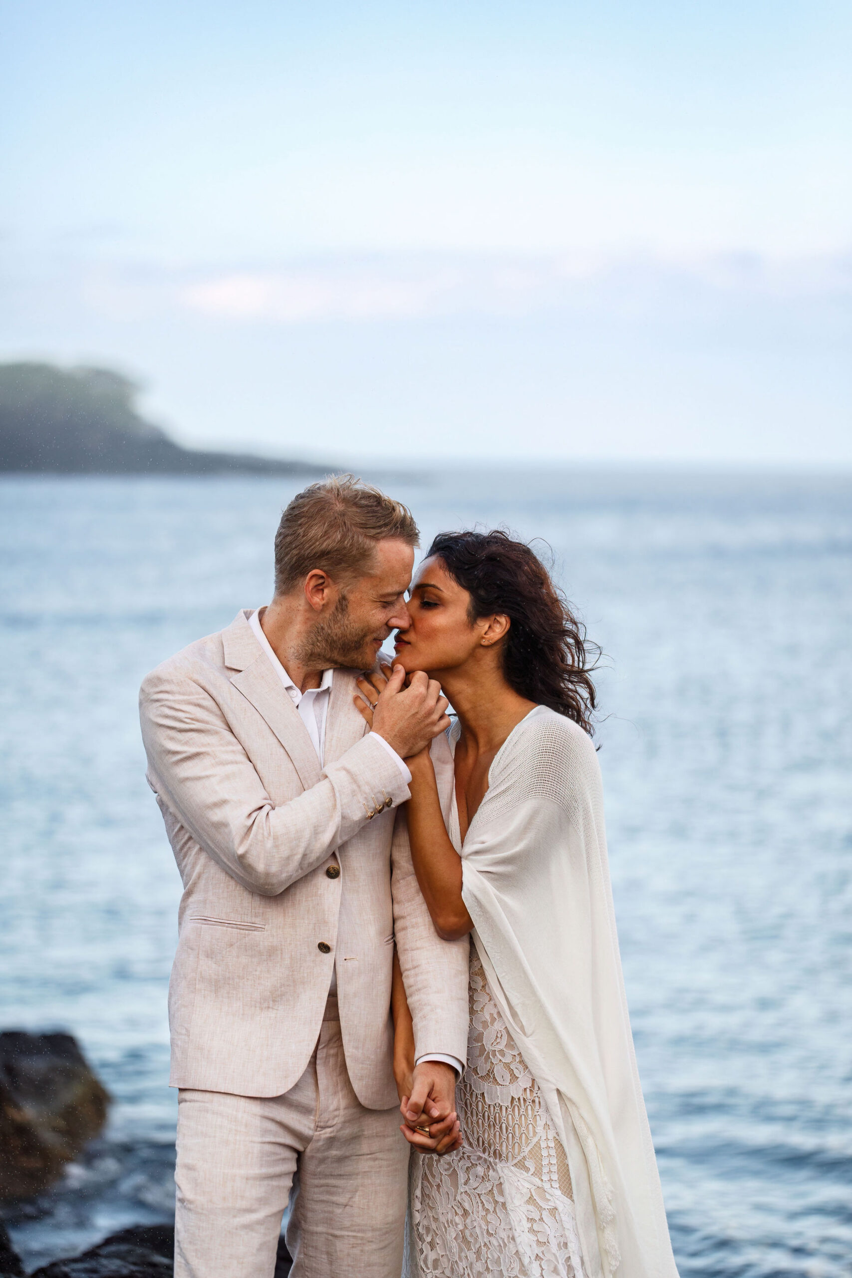 newly weds about to kiss each other on the beach