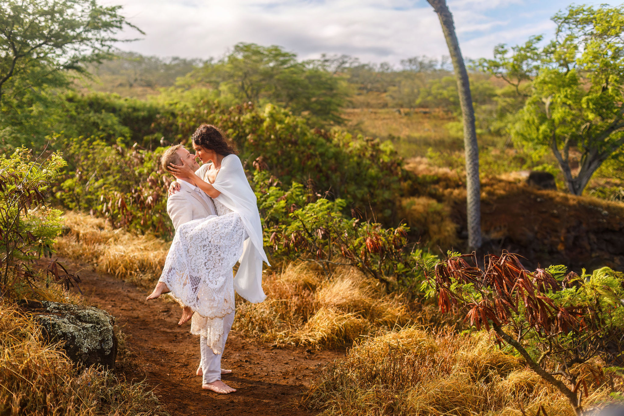 a man holding a woman during their adventurous Hawaiian elopement