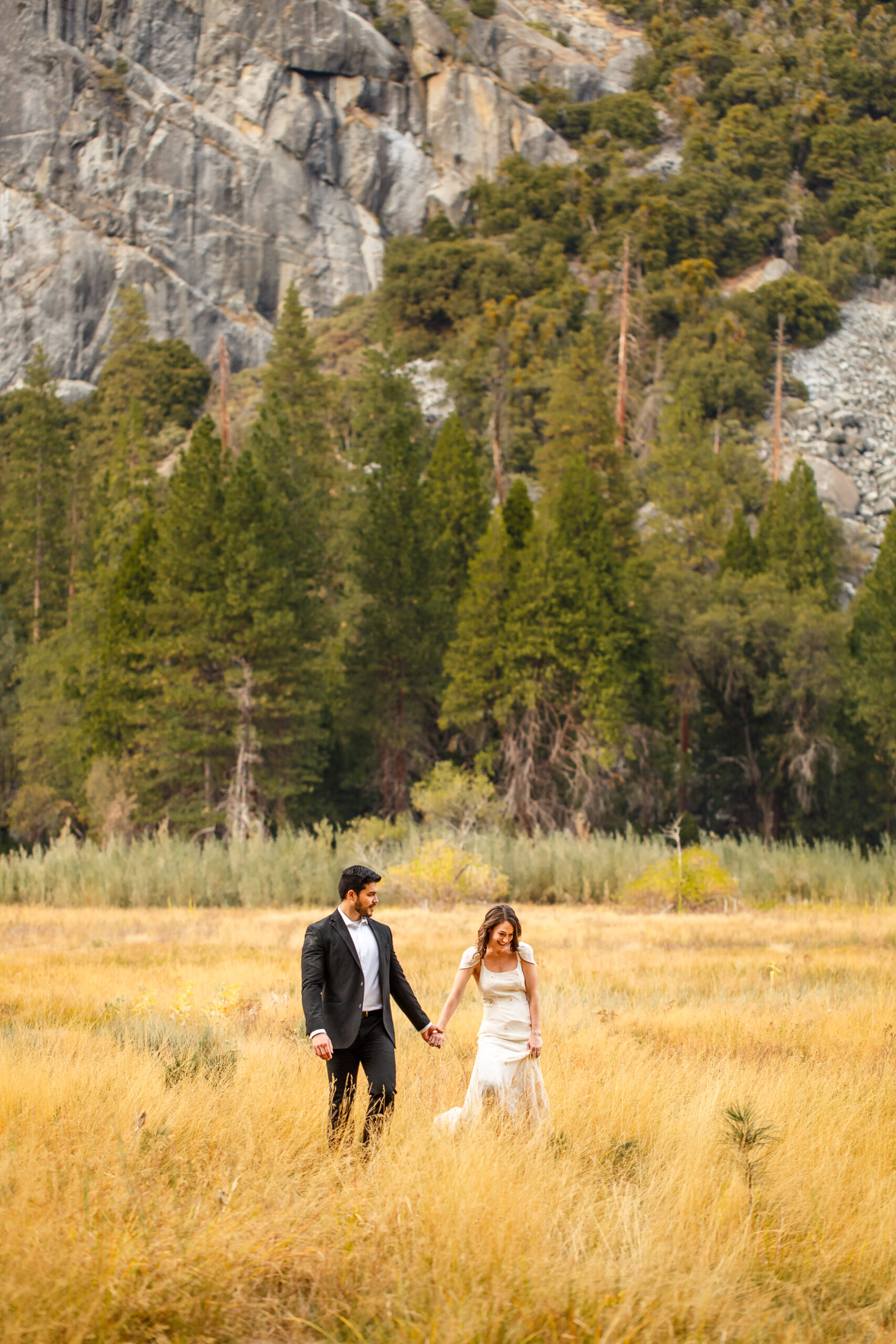 newly weds walking through a valley in Yosemite during their elopement timeline