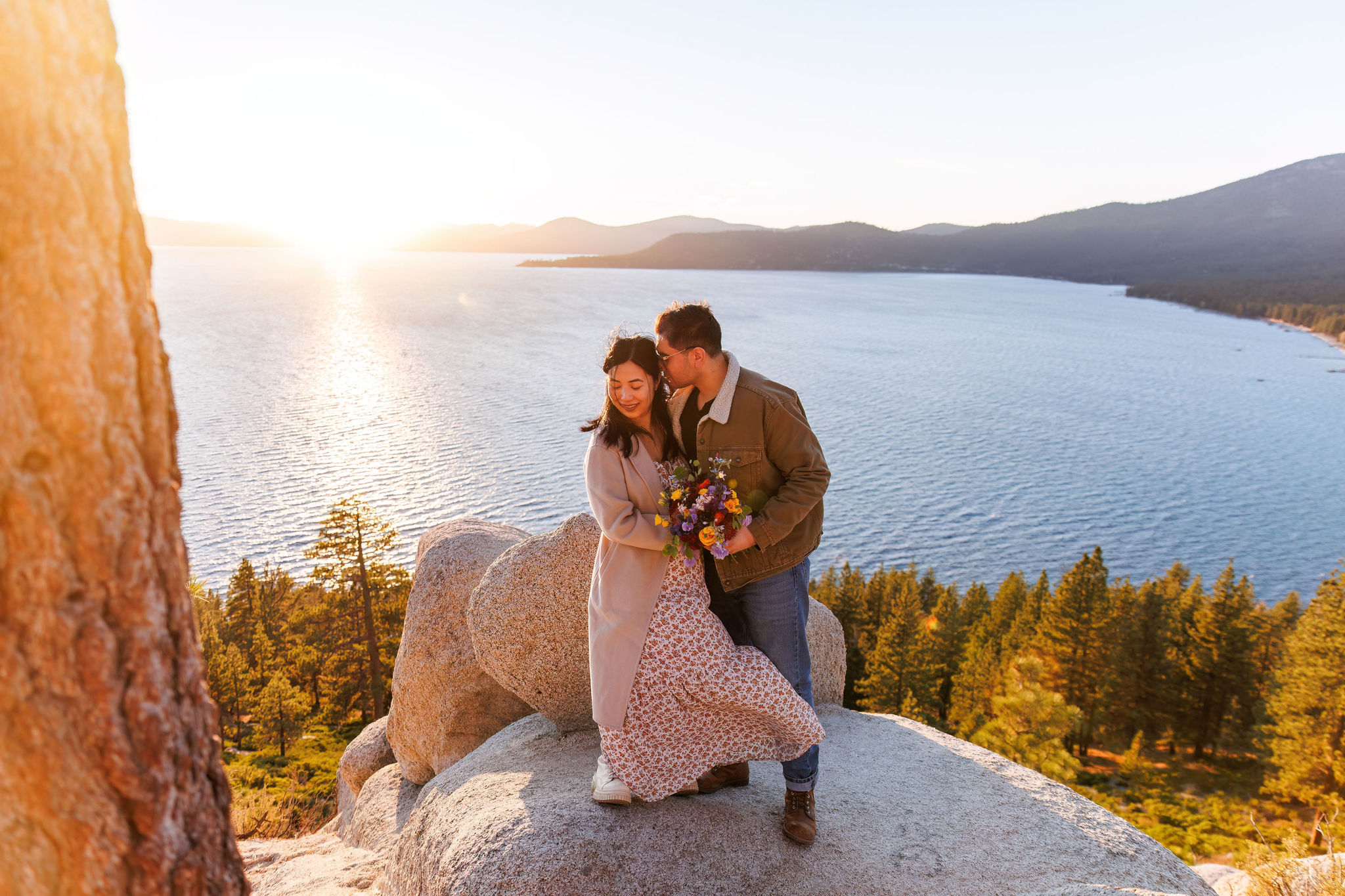 the bridal couple snuggling with the view of Lake Tahoe behind them