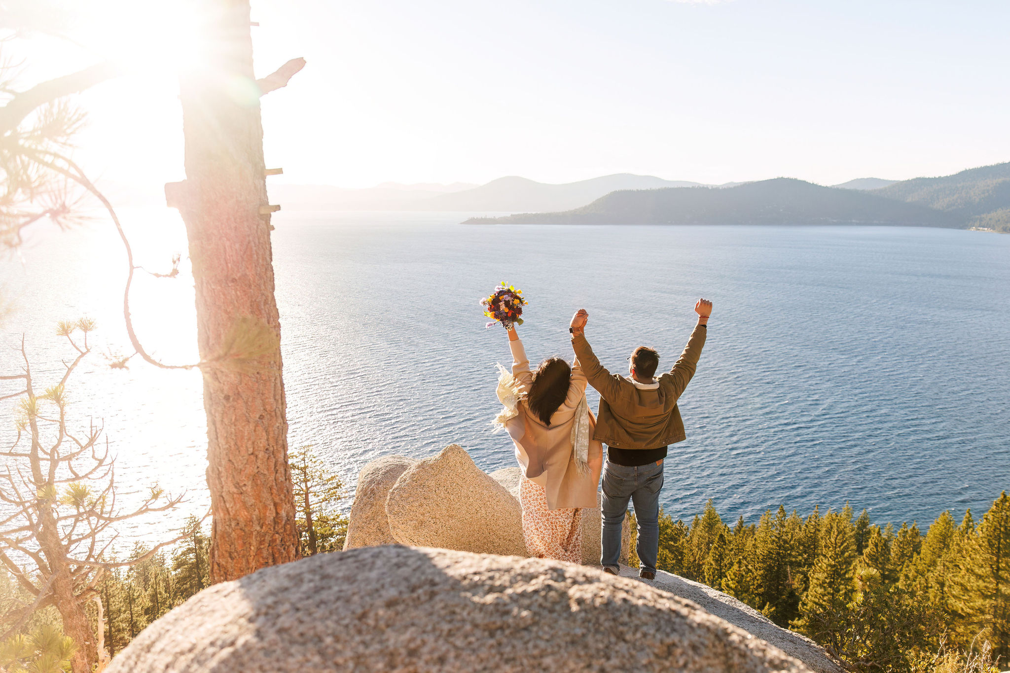 newly weds standing on an epic lookout during their adventure elopement in Tahoe
