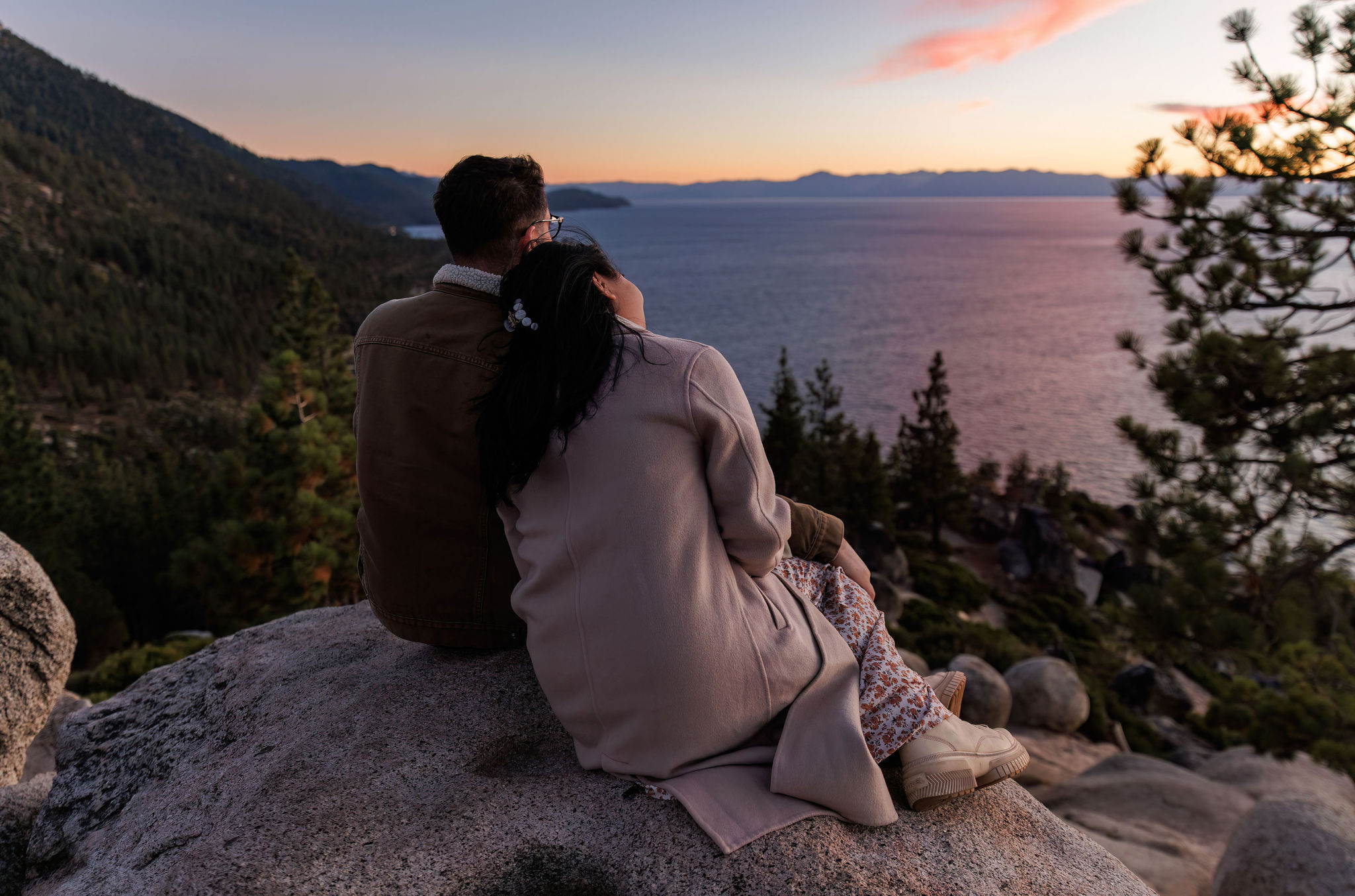 a couple enjoying the sunset over Lake Tahoe during their adventure elopement