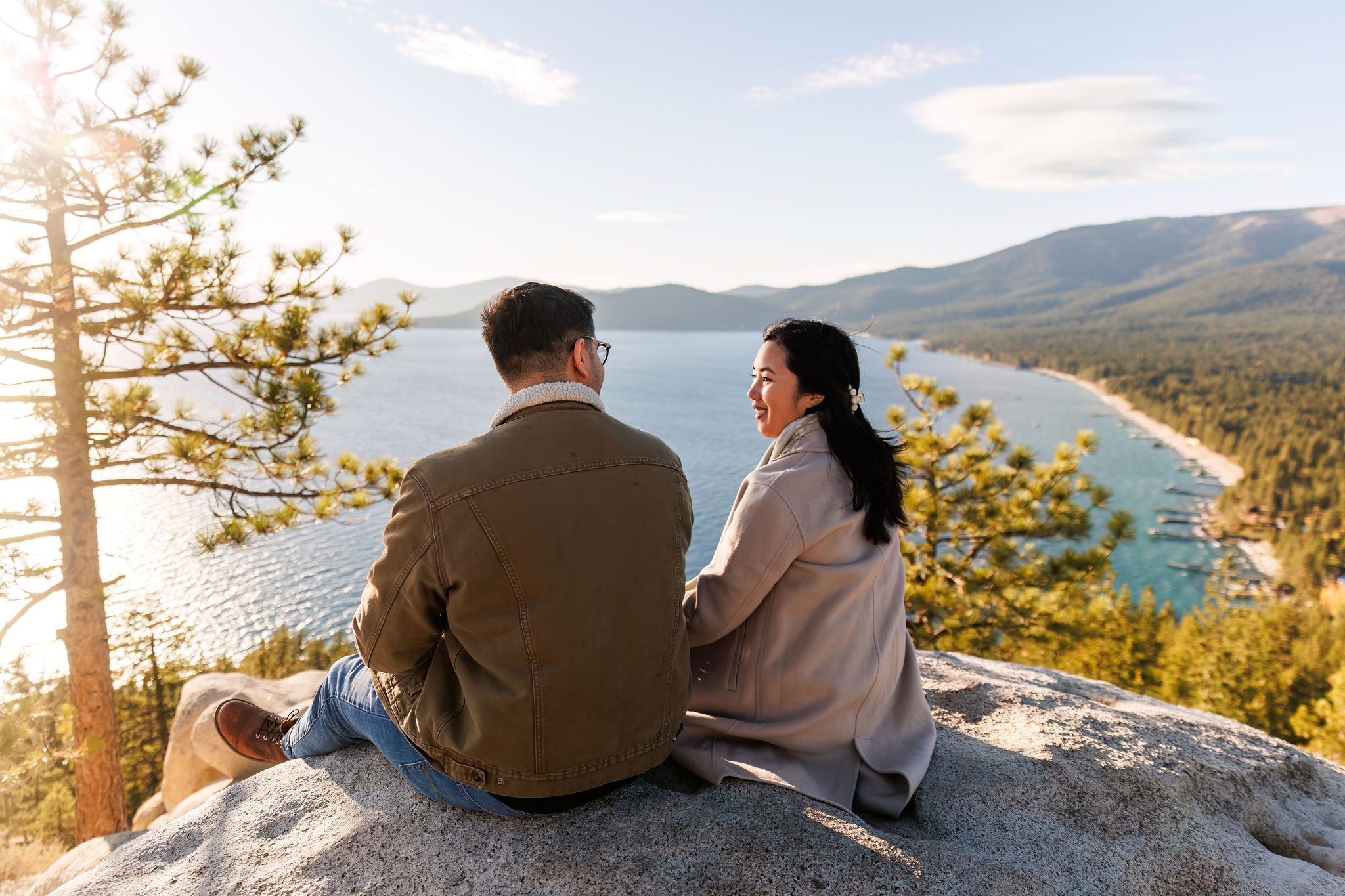 a couple sitting on a rock together about Lake Tahoe during their adventure elopement