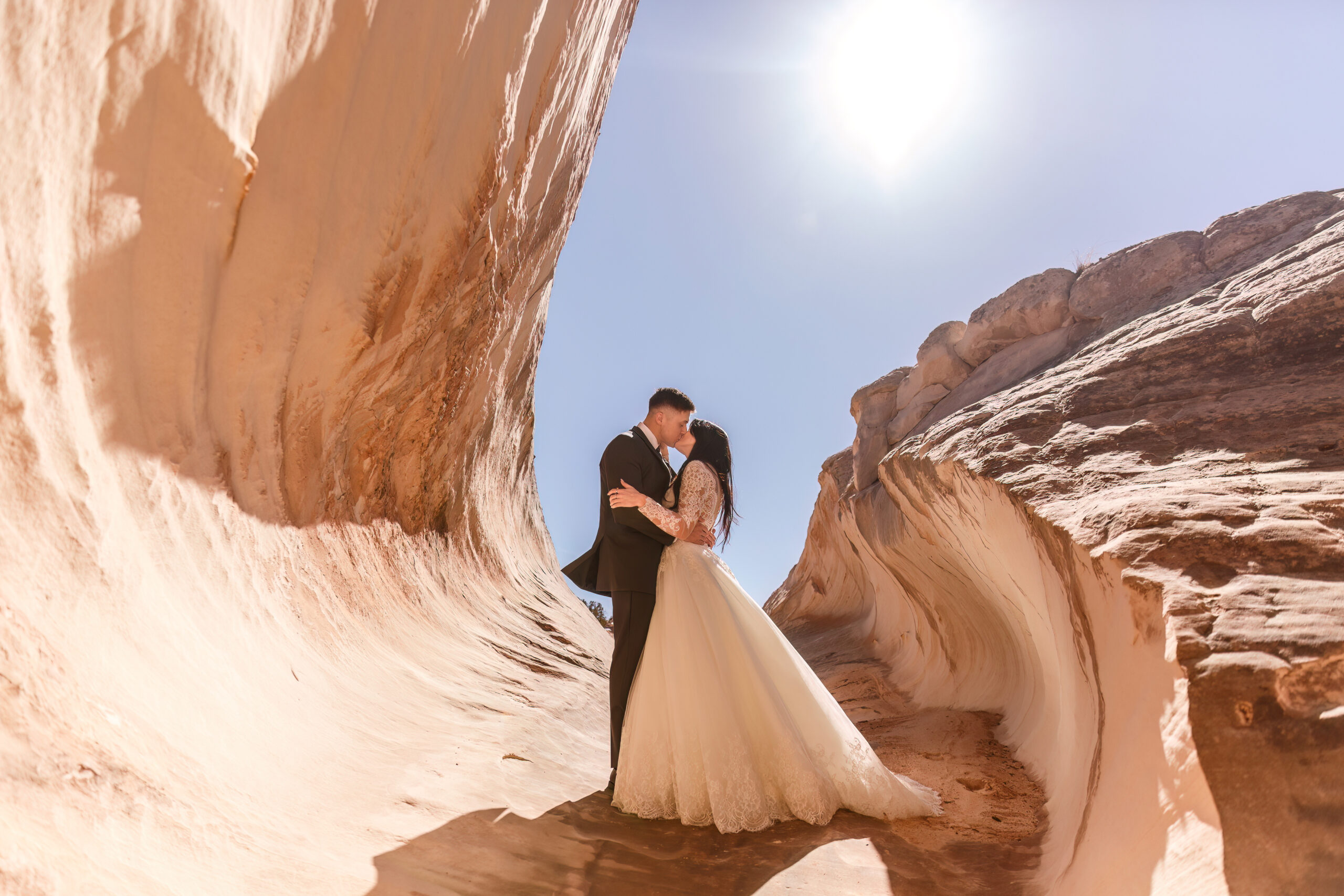 a couple in some swirling rocks for their elopement portraits