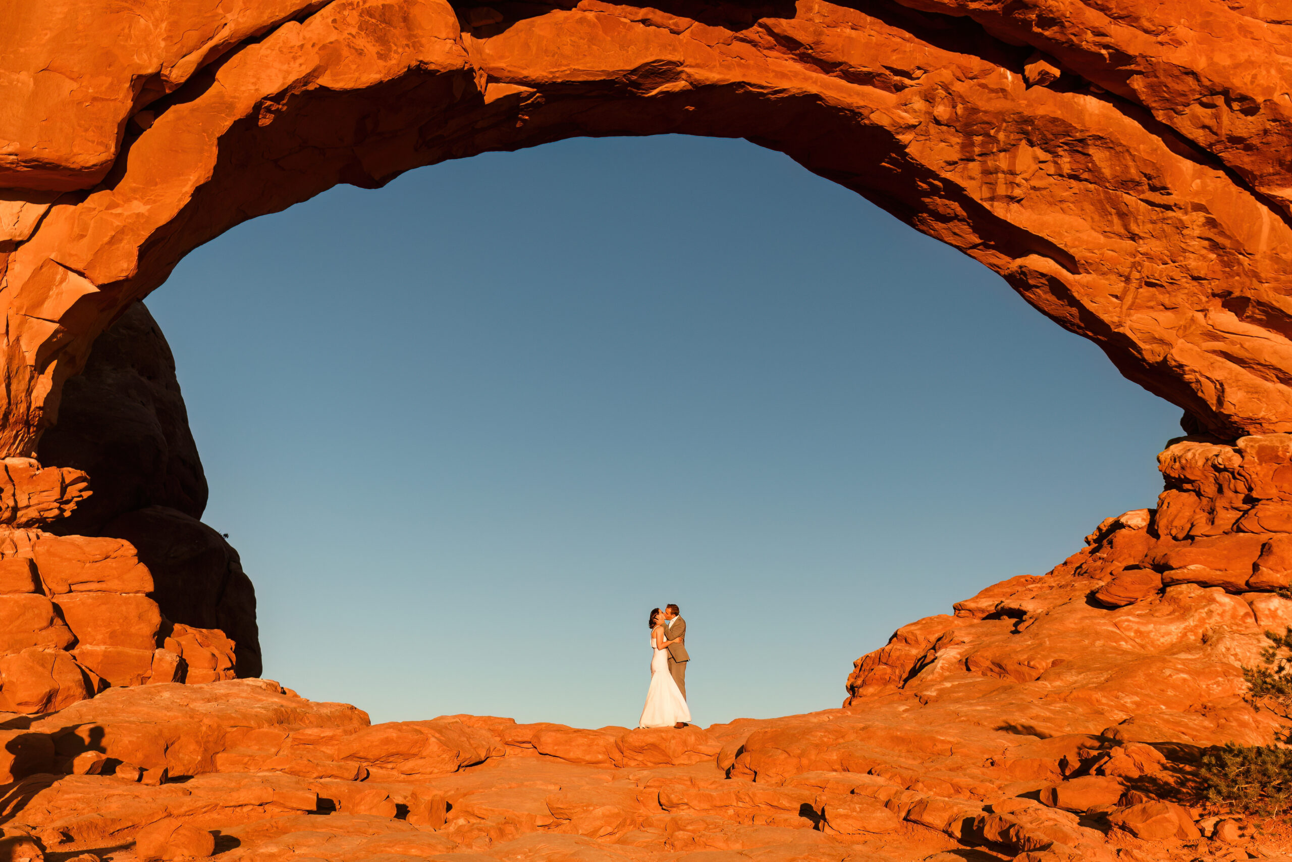 newly weds under a desert arch