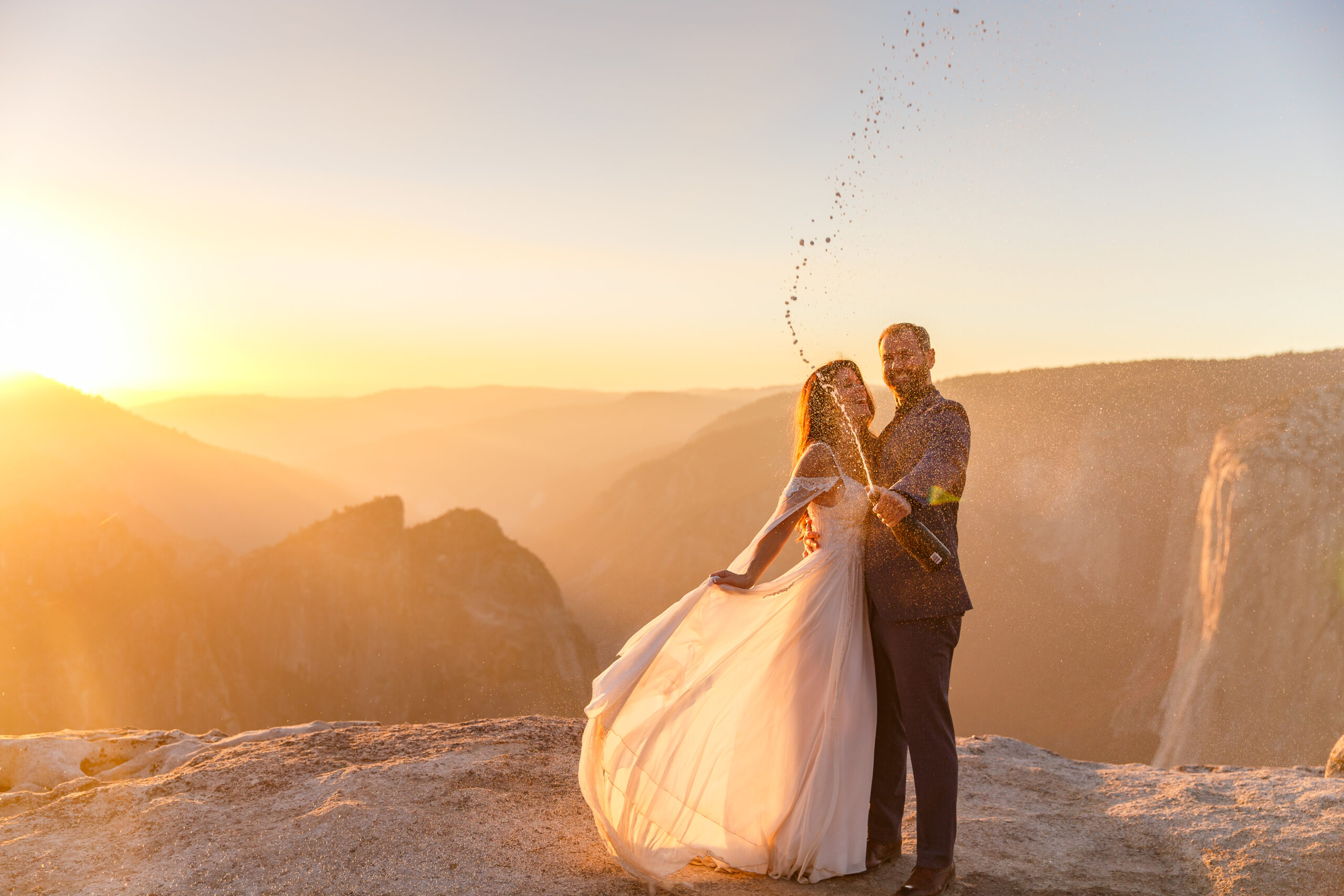a couple taking a moment in their elopement timeline to pop some champagne