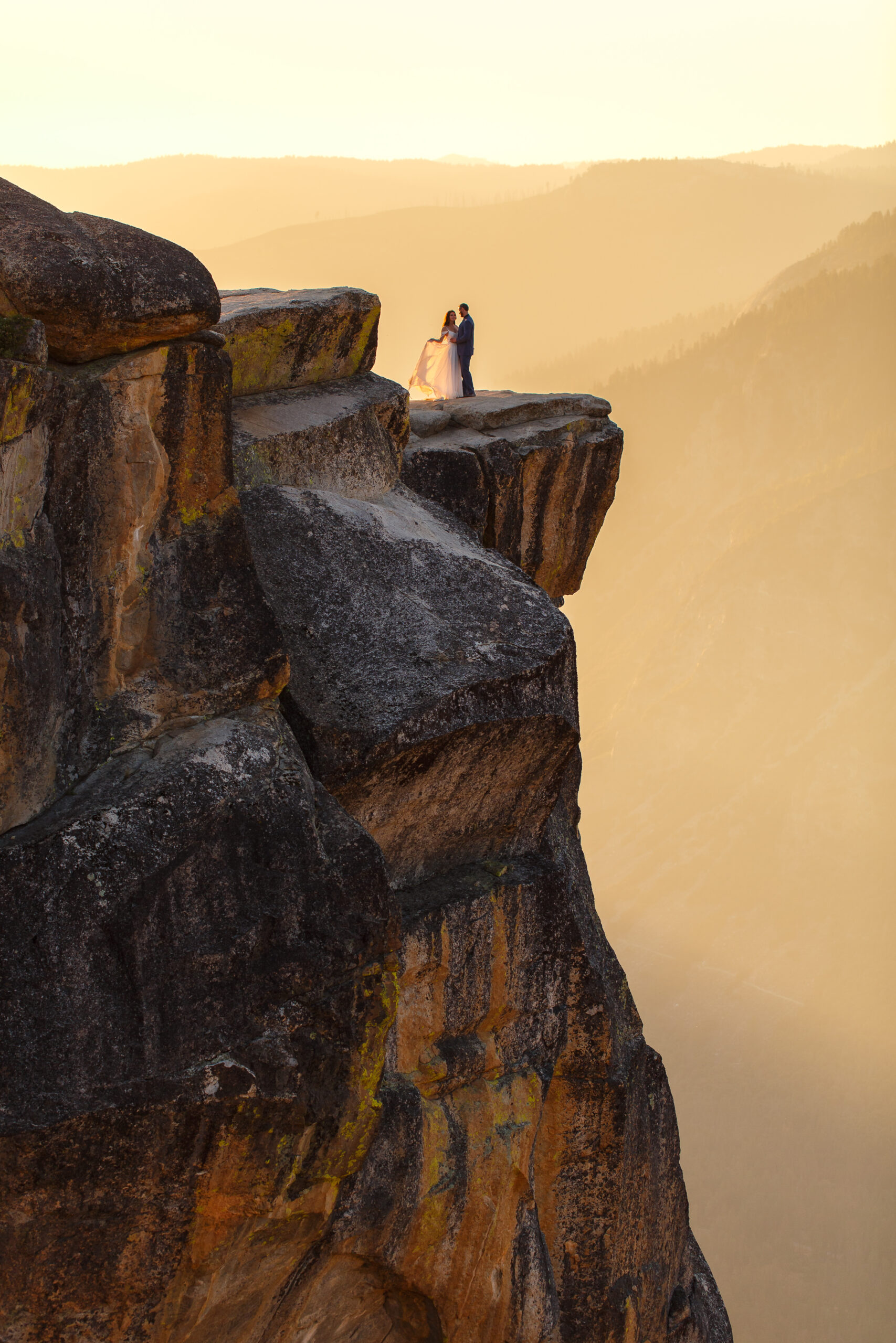 a couple on top of a mountain in Yosemite