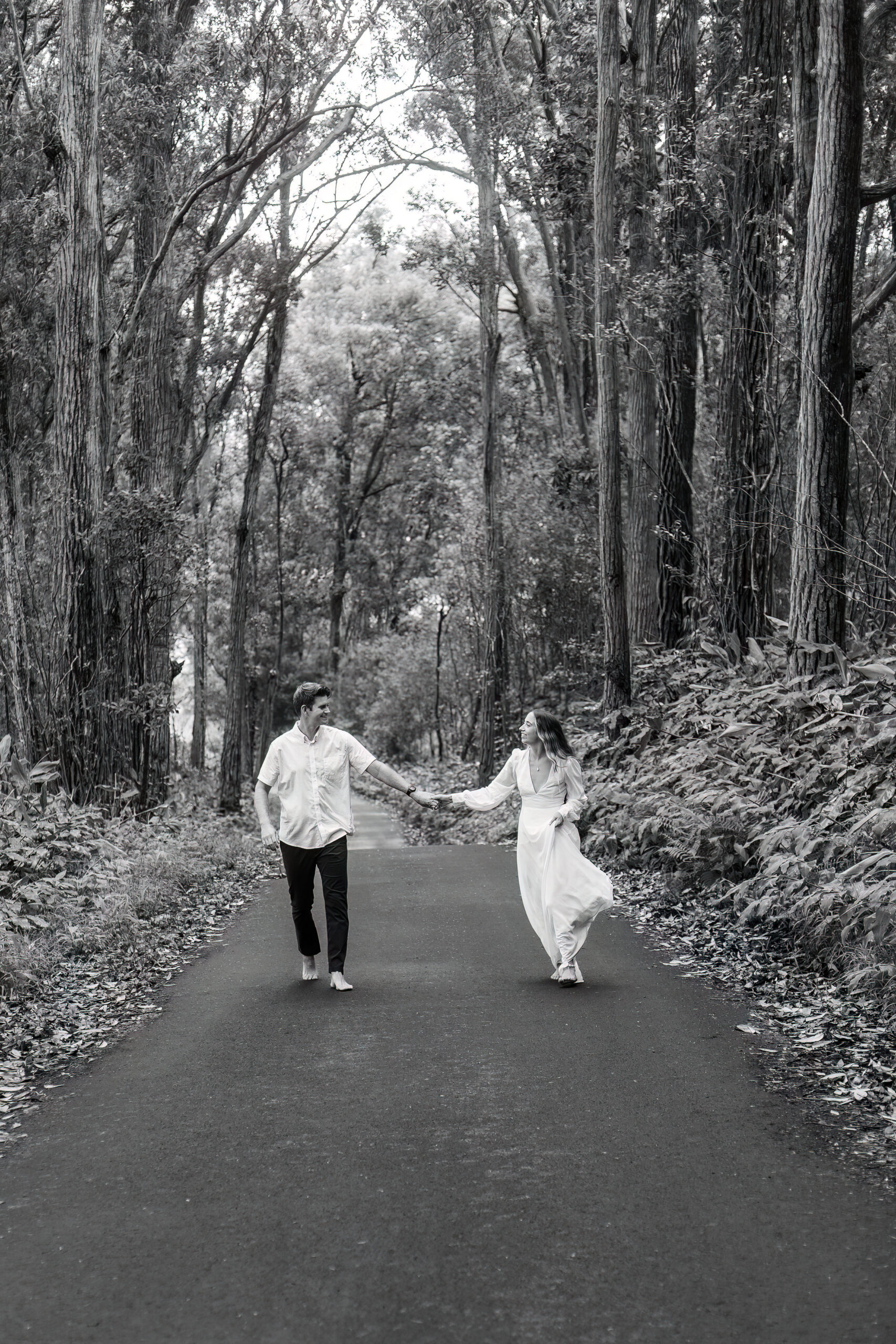 black and white of a bride and groom walking on their elopement day
