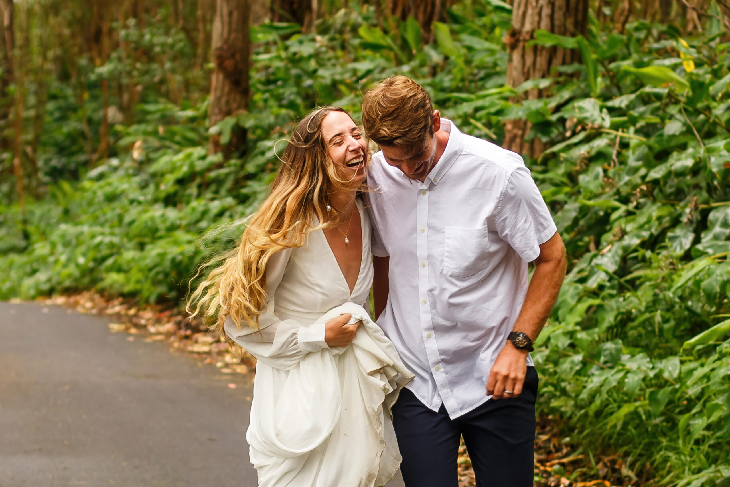 a couple laughing and walking in nature together during their adventure elopement