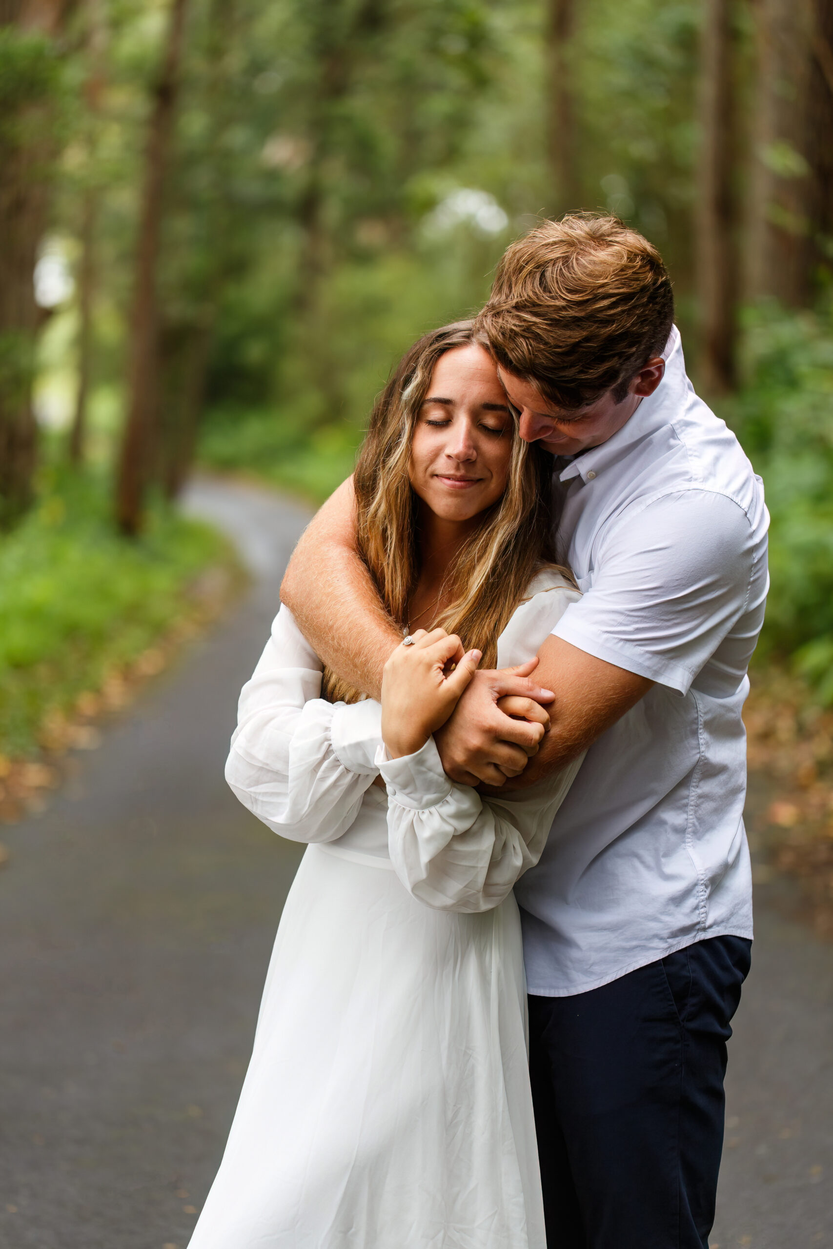 a man hugging a woman from behind on their wedding day