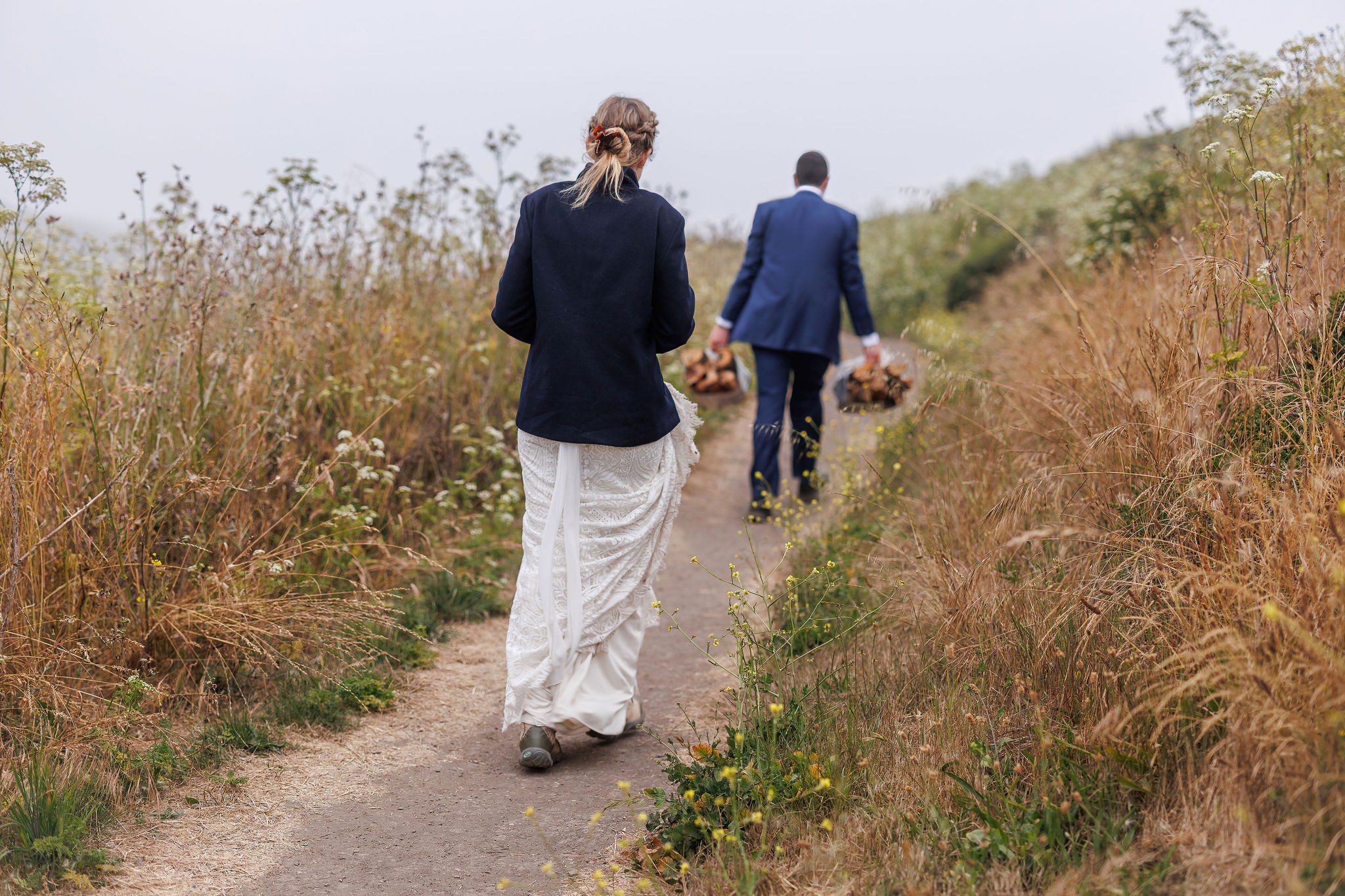 newly weds walking to the beach to have a fire during their Point Reyes elopement