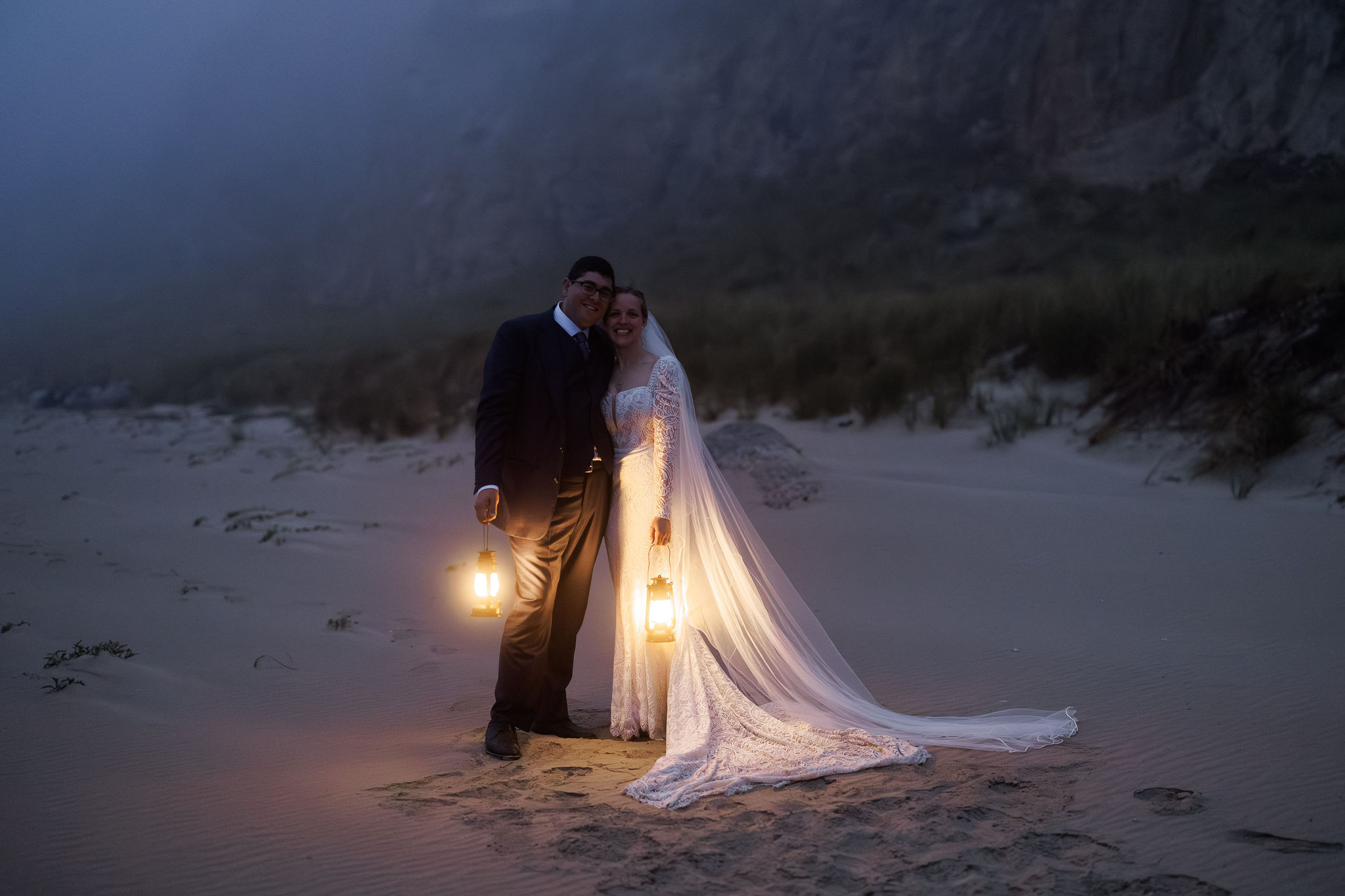 bride and groom smiling on the beach
