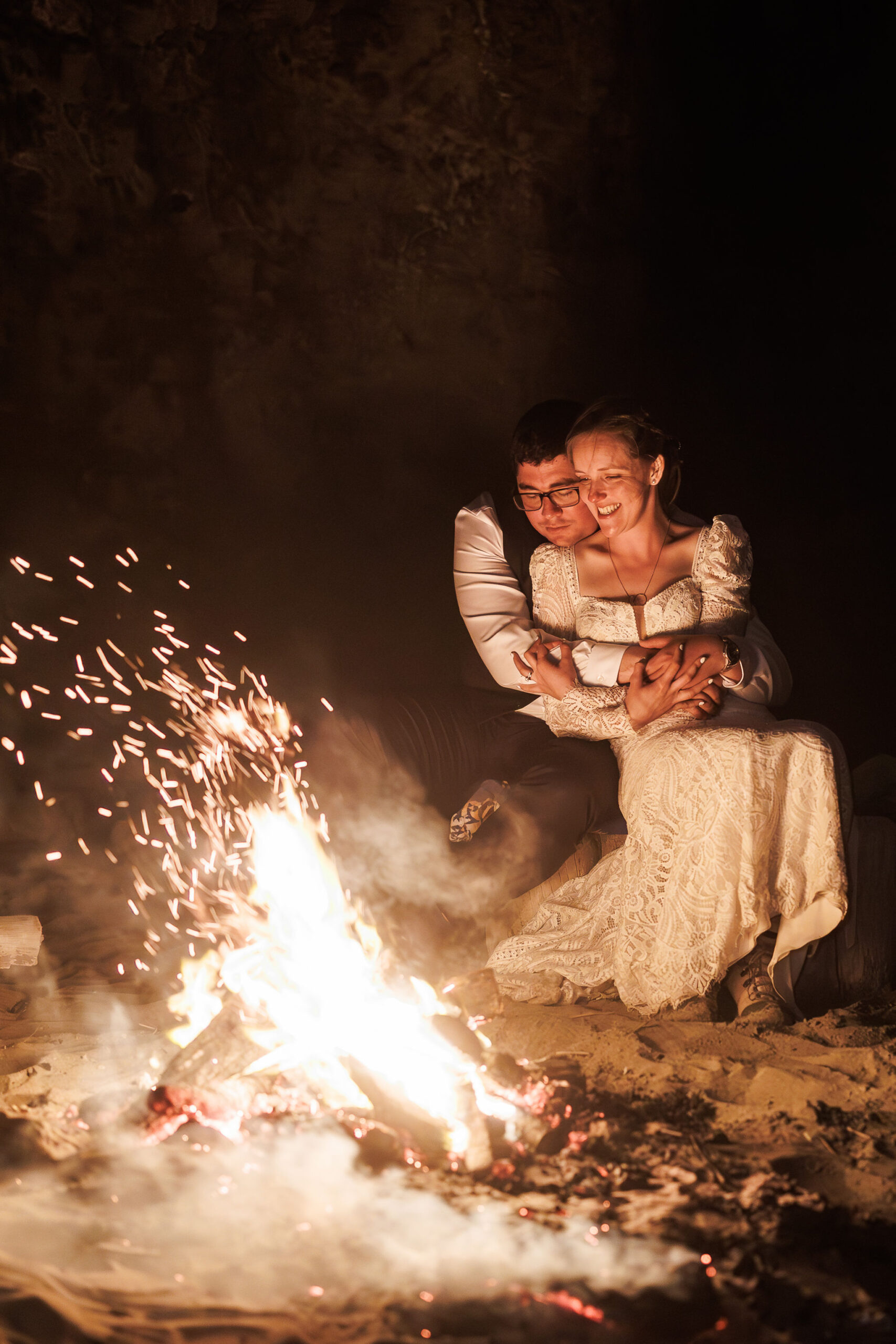the couple sitting around the fire