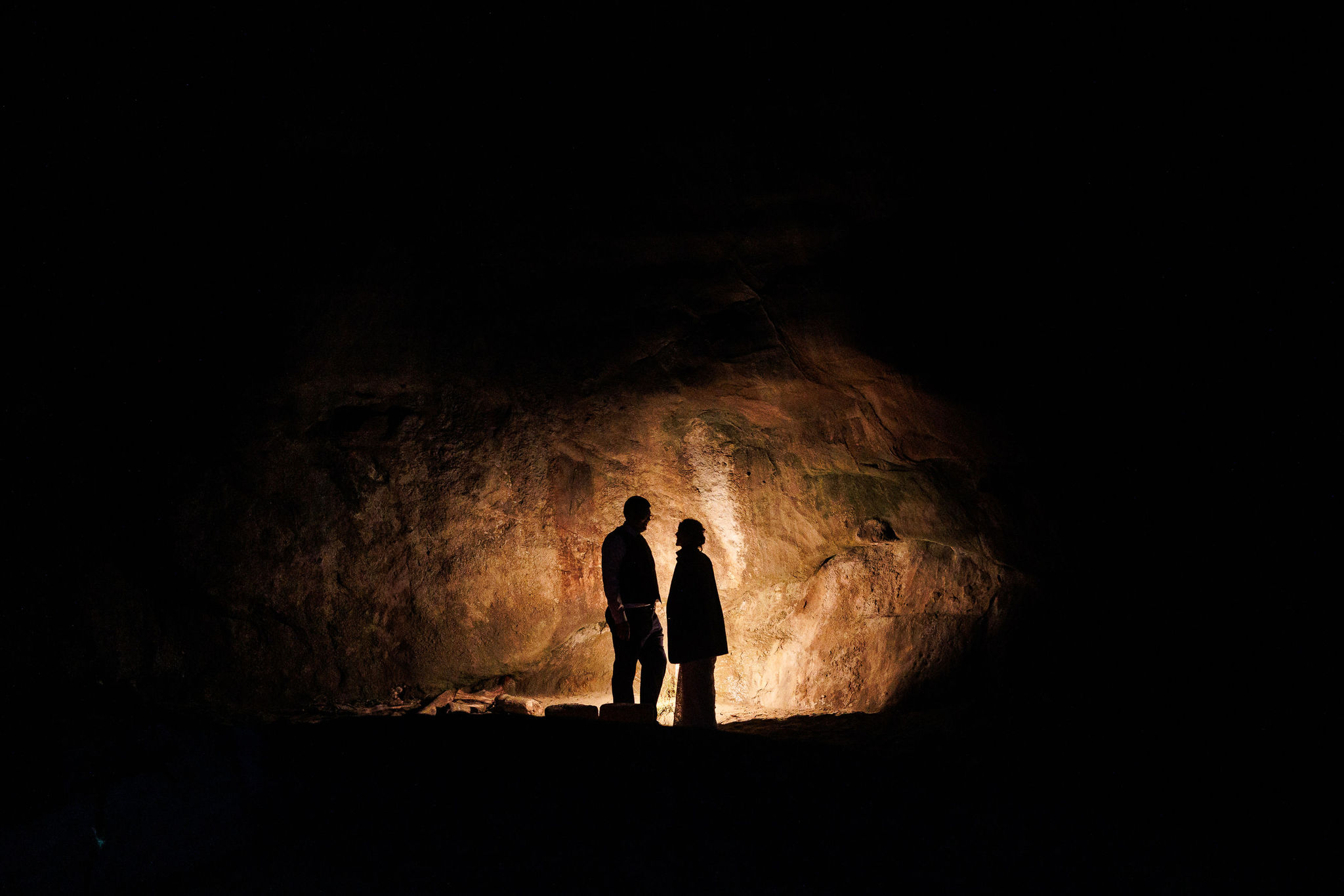 the couple standing in the fire's light