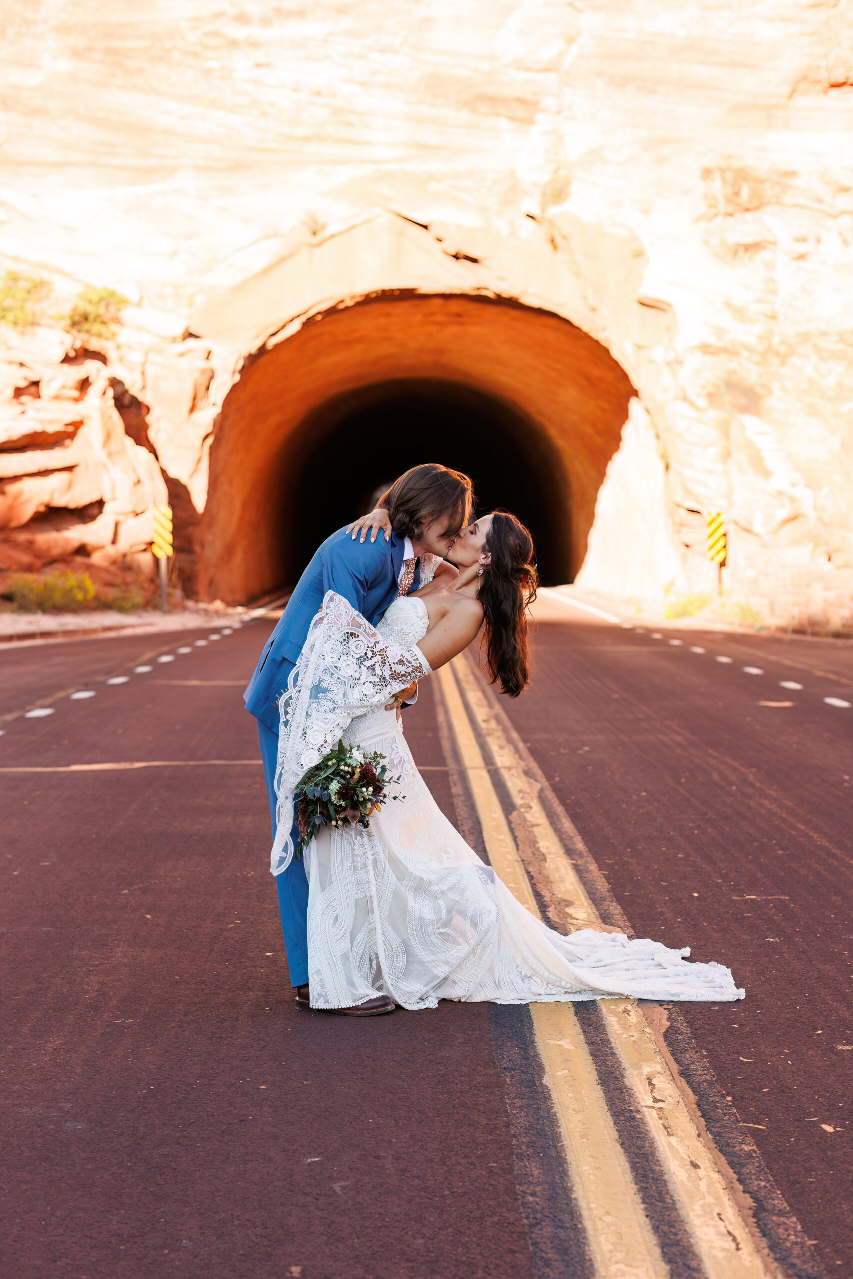 mountain elopement portraits on the road in front of a tunnel 