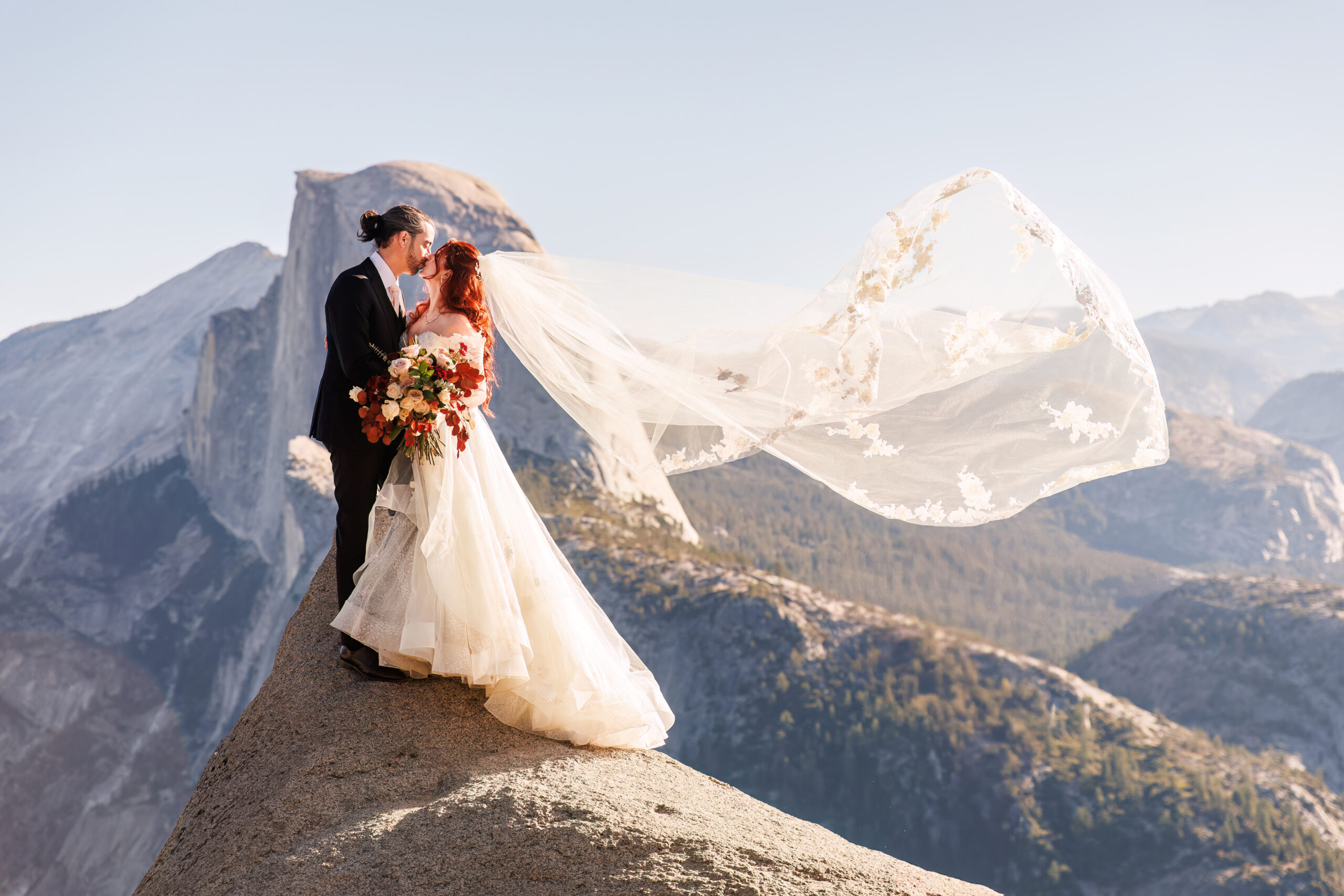 a couple standing on a mountain during their mountain elopement 
