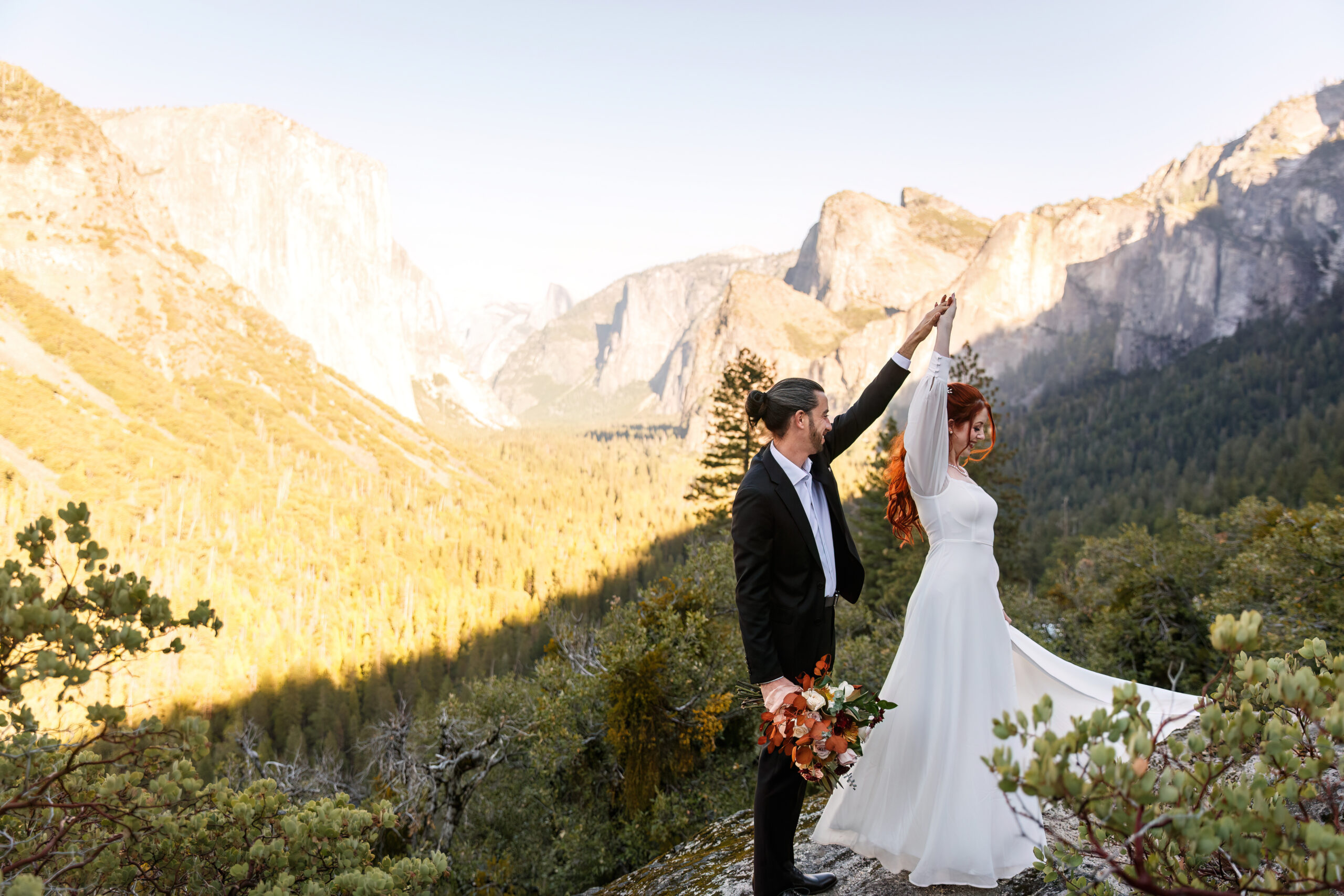 a couple dancing in the trees during their mountain elopement 